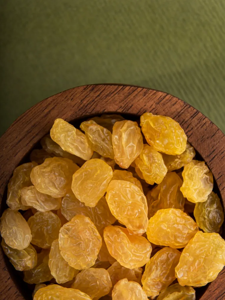 Malekan golden raisins in a wooden bowl